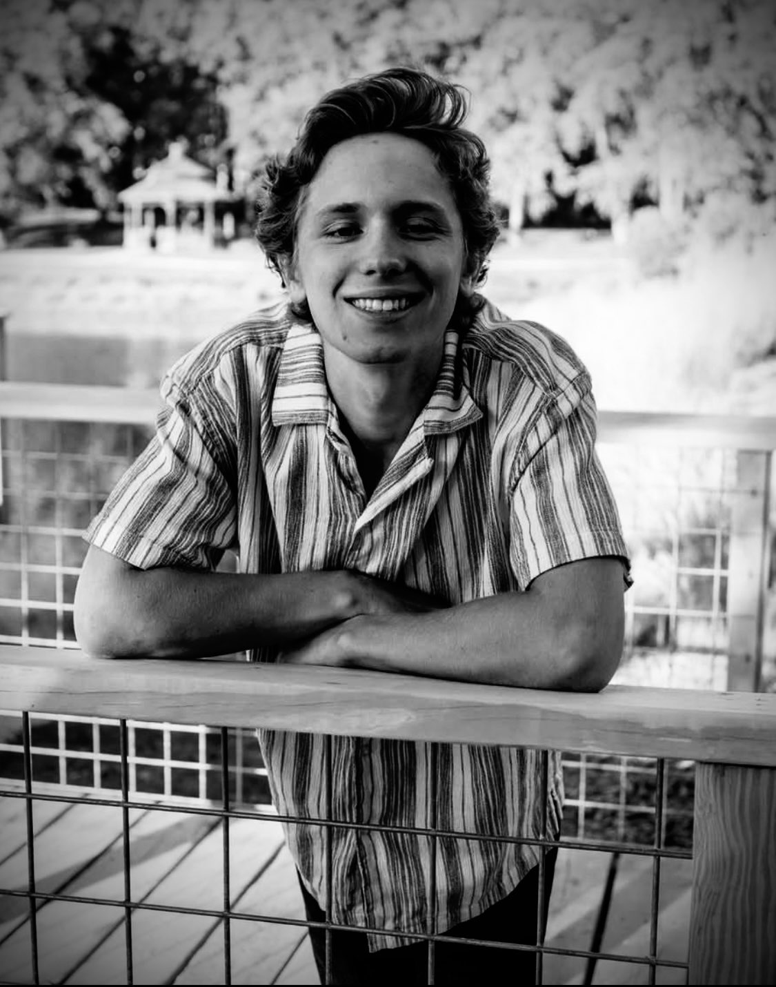 Black and white portrait of Ryder Mann on the railing