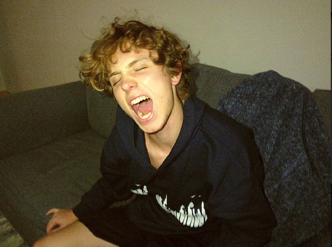 Ryder Mann mid-shout on a couch